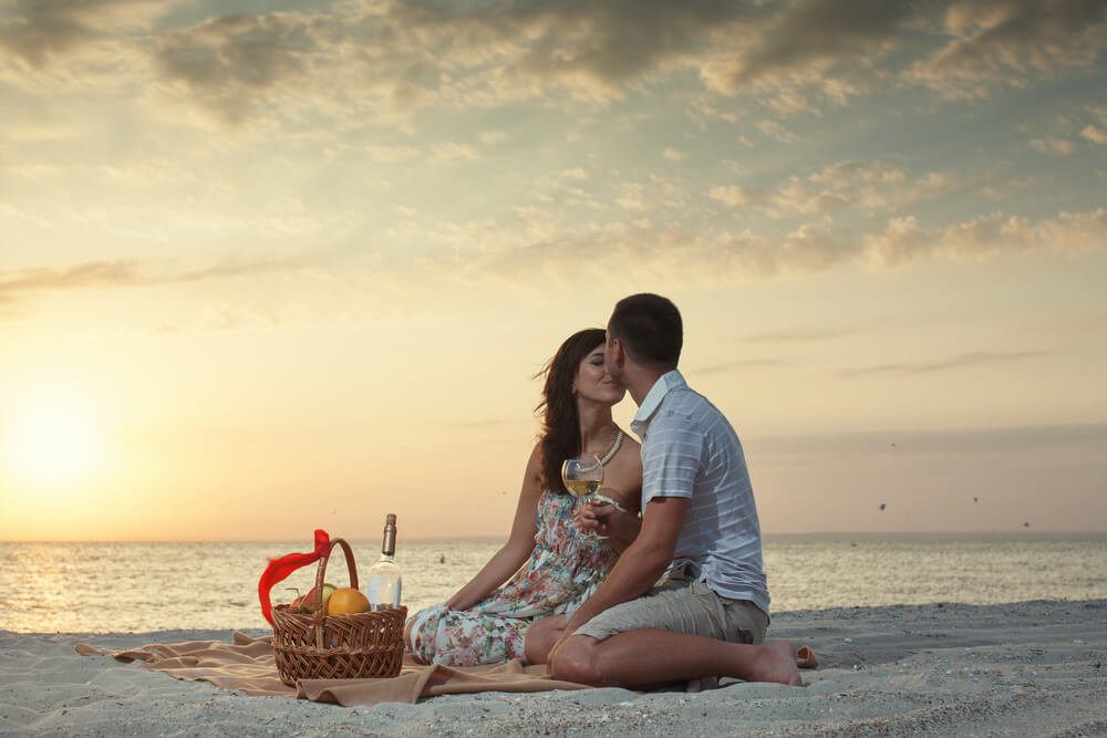 Photo of a couple on a beach date.