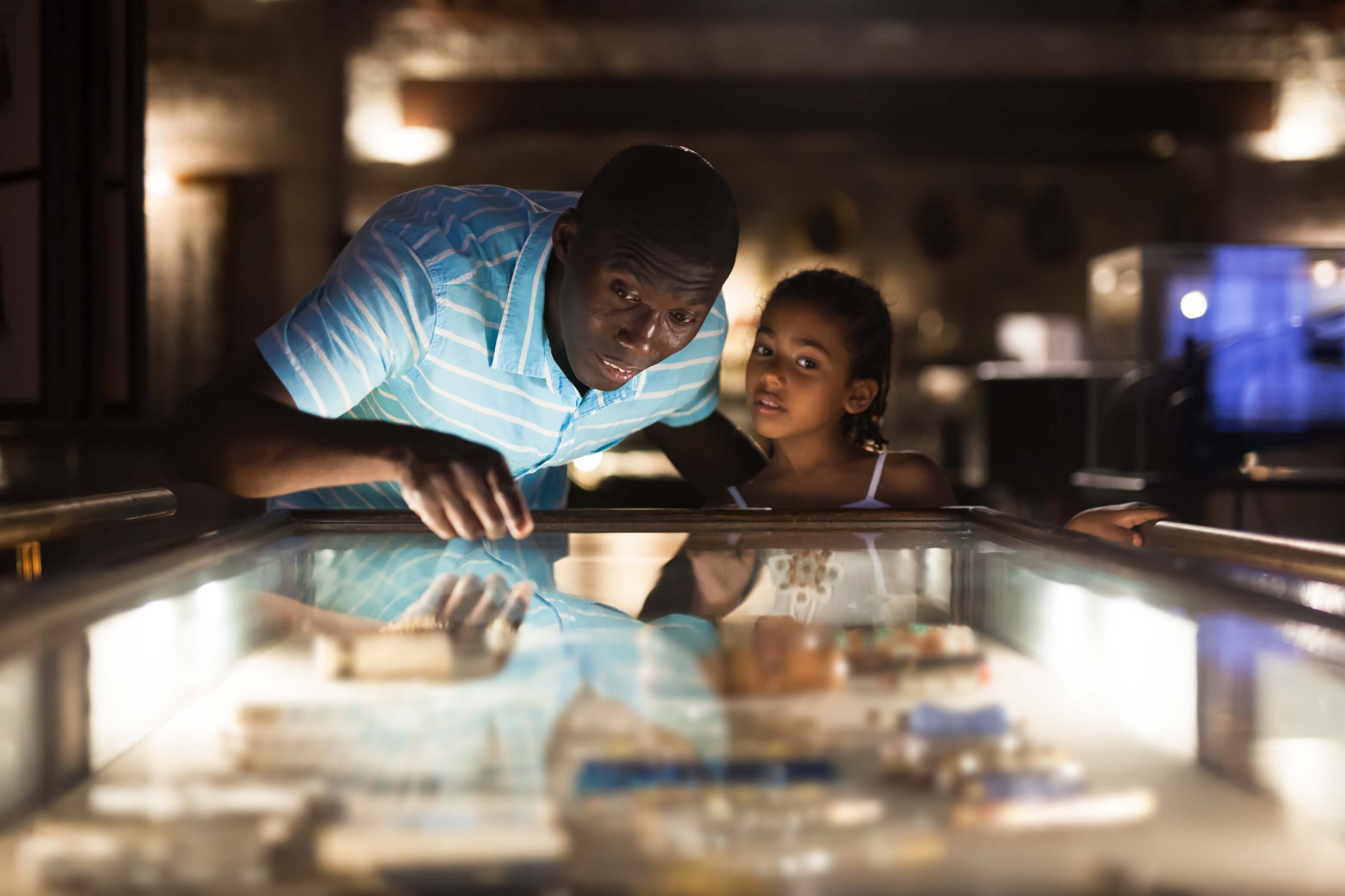 A man and a child looking at an exhibit in museums in Oregon.