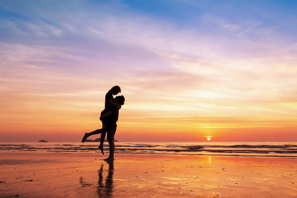 Photo of Two Honeymooners on the Beach at Dusk. Click Here to See an Oregon Coast Honeymoon Planner.