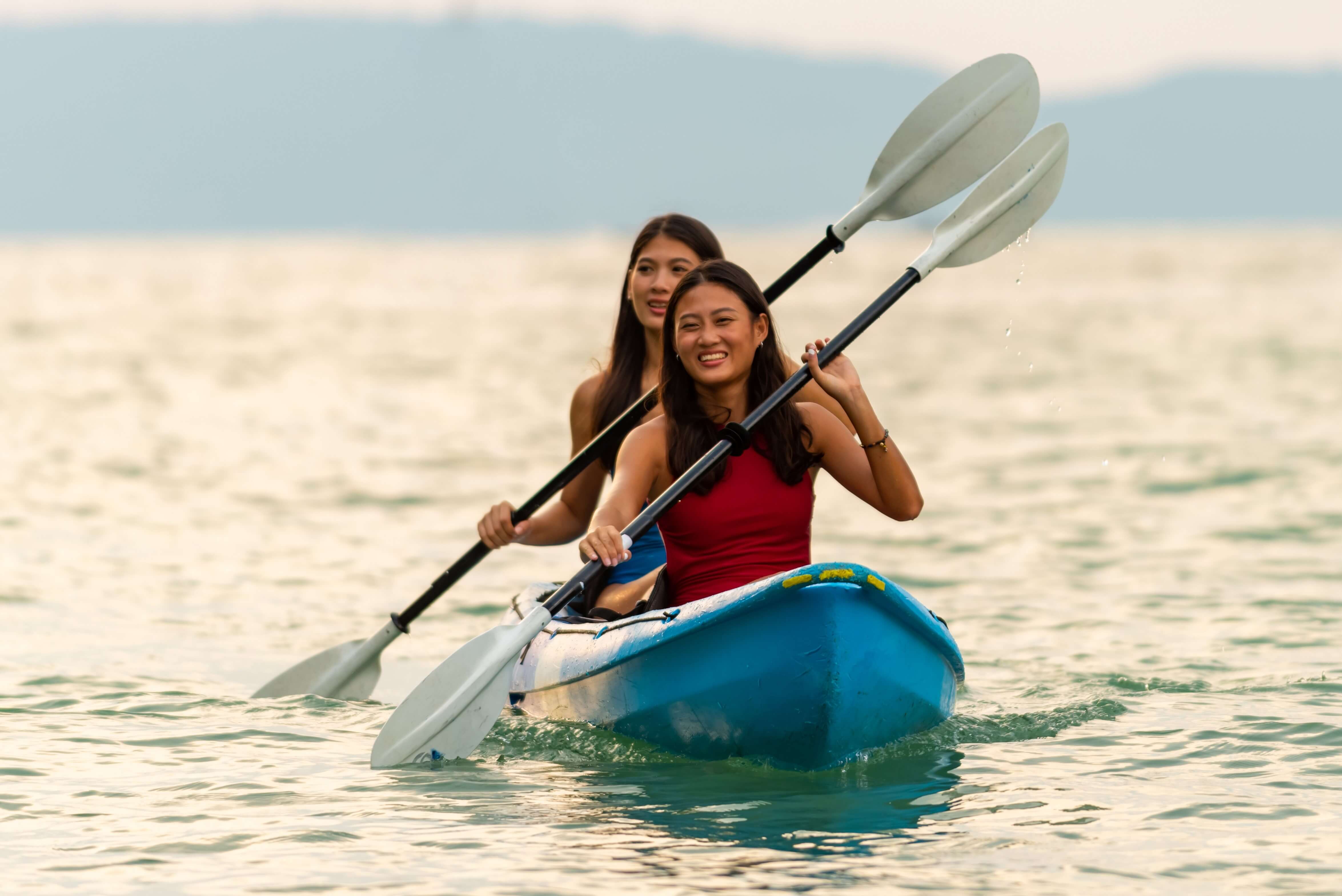 Two women kayaking and enjoying their Oregon Coast Kayak Rentals. 