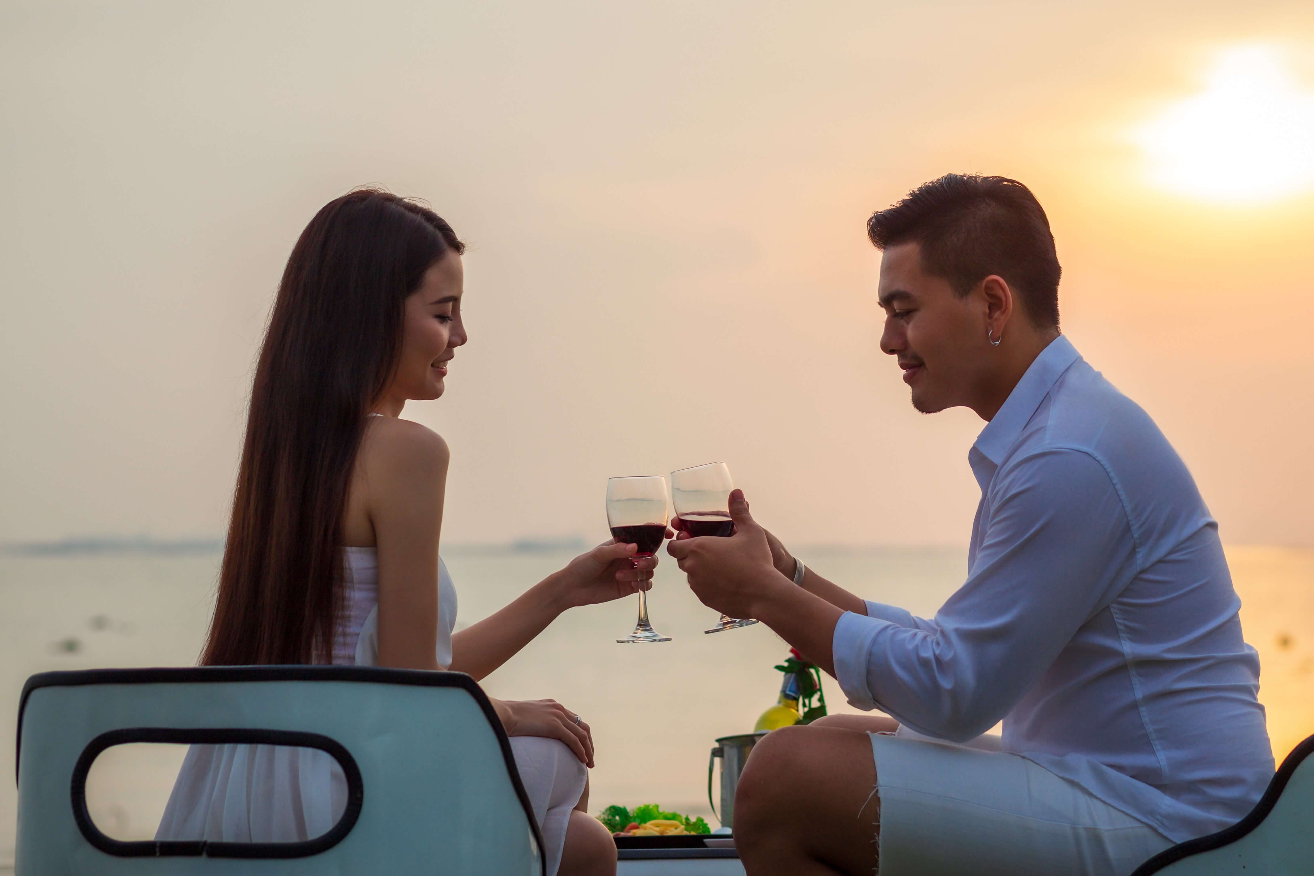 A woman and a man drinking wine from Oregon coast wineries.